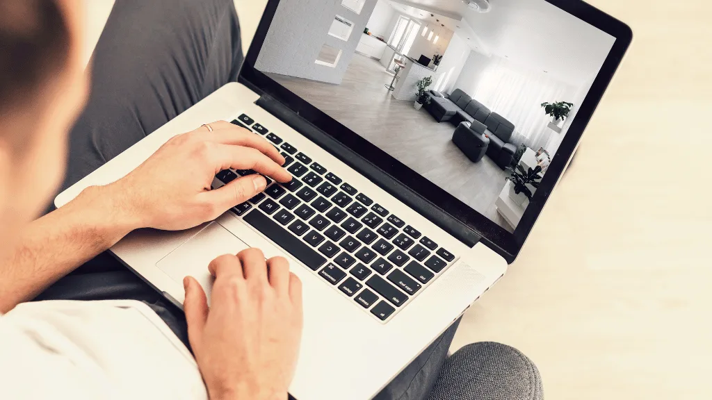 How Property Websites Can Help Guide Apartment Shoppers | PERQ AI Leasing Assistant a laptop on someone's lap showing a virtual tour of an apartment