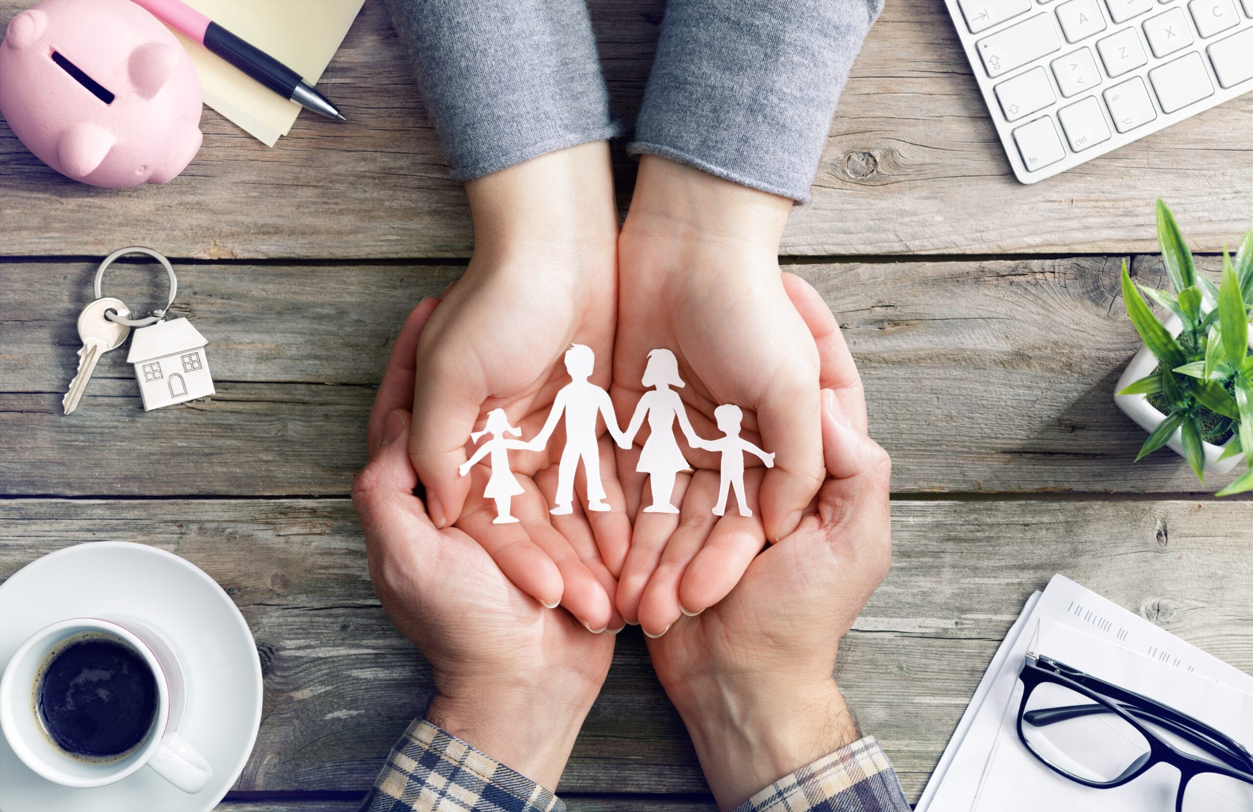 hands holding people figurines