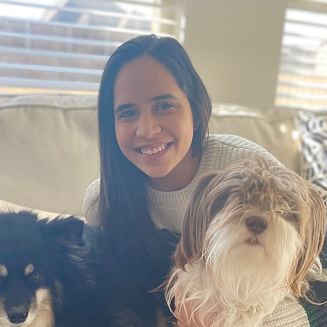 Fabiana Soto from PERQ smiling with two dogs