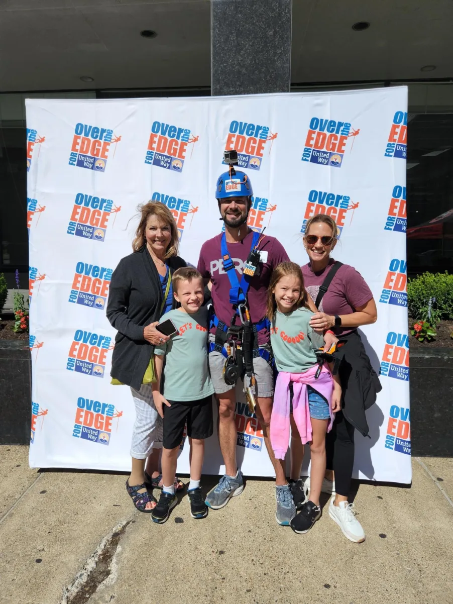PERQ CEO Goes Over the Edge (For a Good Cause) | PERQ AI Leasing Assistant family posing at the Over the Edge for Uniter Way climbing community service event