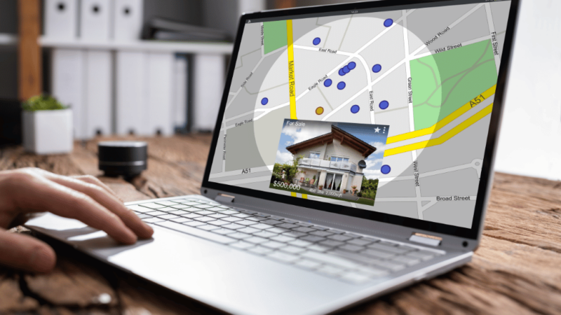 a laptop screen showing a picture of a home overlaying a digital map